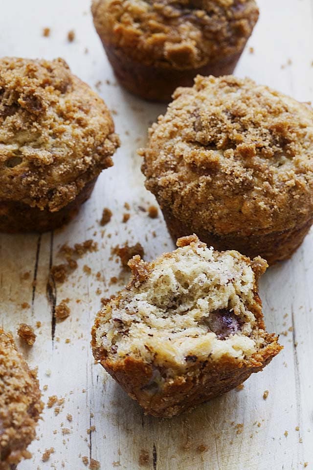 The inside of a banana muffin with crumbs on the top and mashed banana inside the muffin. 