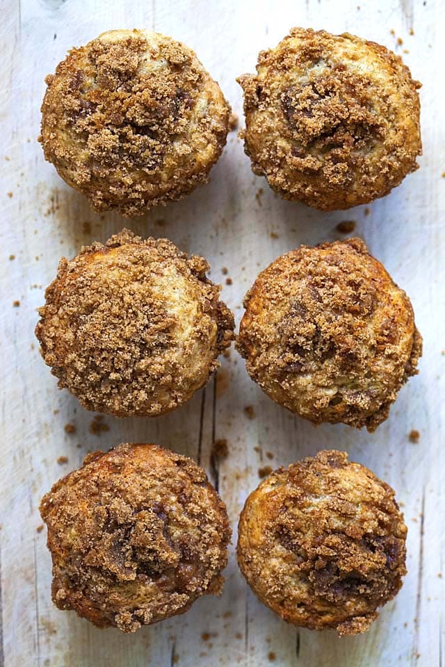 Top down shot of six banana crumb muffins on a tray.