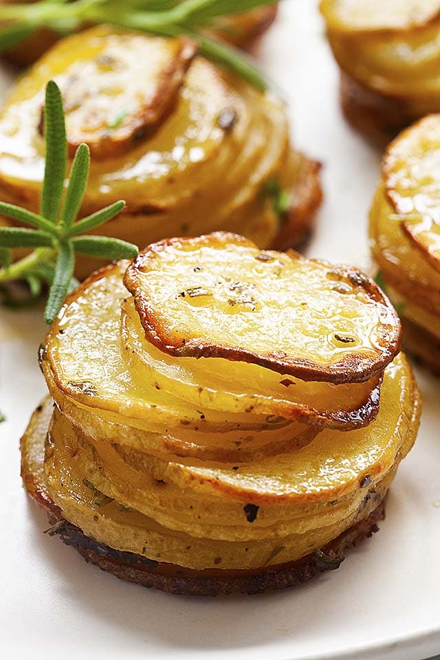 Three potato stacks stacked up together on a plate.