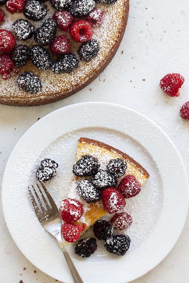 Cutting out a piece of French yogurt cake from one whole yogurt cake.