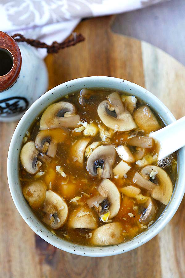 Tofu, mushrooms and egg in a spoon full of easy hot and sour soup.