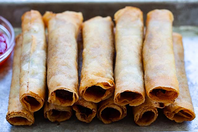 Several rolls of fried lumpiang Shanghai with ground pork and vegetable filling.