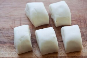 Cutting char siu bao dough into pieces.