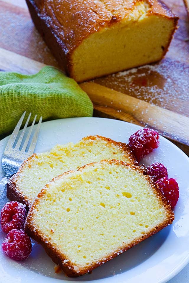 Top down shot of a loaf of cream cheese pound cake, dusted with powdered sugar.