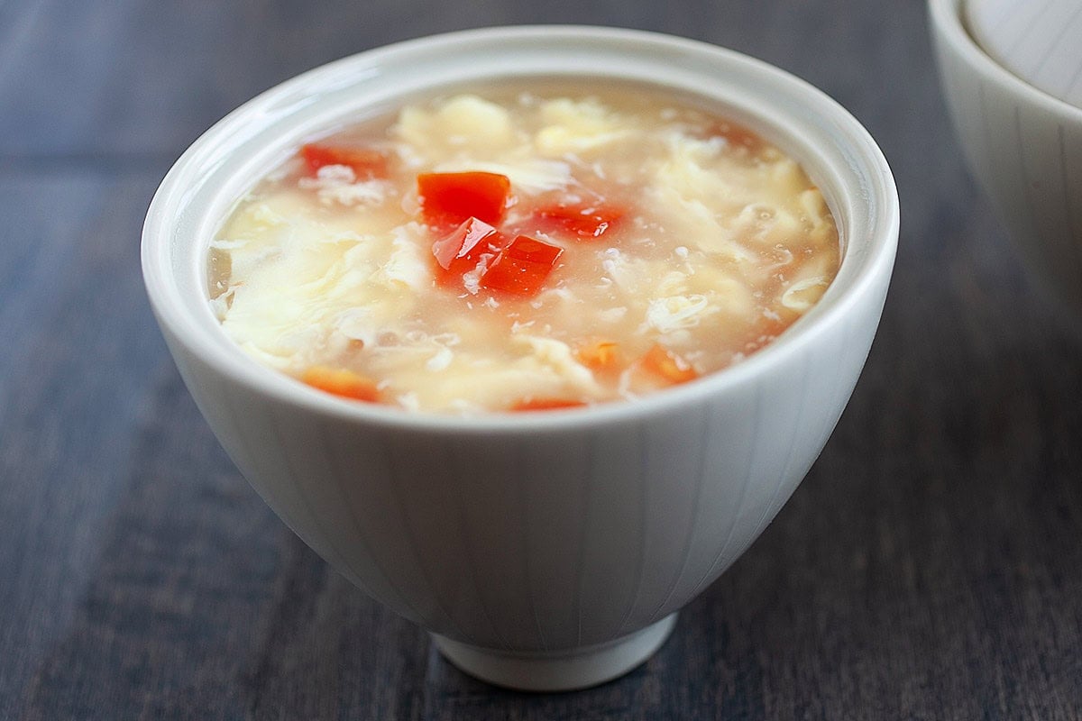 Homemade egg drop soup with tomatoes, eggs and chicken broth. 