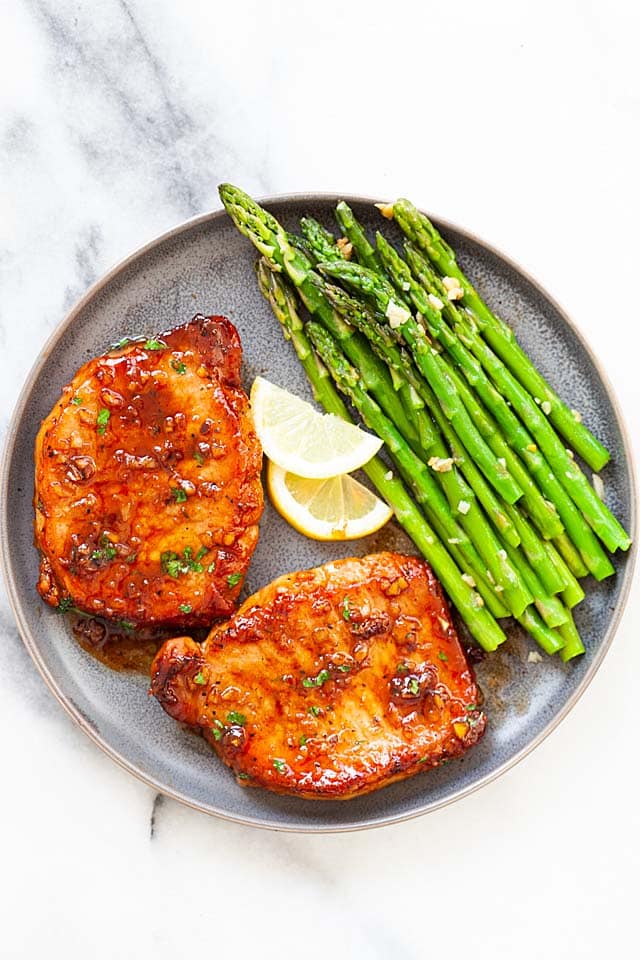 Boneless pork chops (center-cut boneless pork chops) with asparagus on a plate.