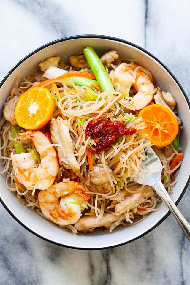 Pancit bihon is Filipino fried rice sticks or rice noodles, served in a bowl, ready to be eaten.