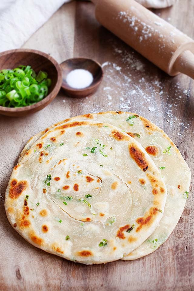 Chinese scallion pancake recipe on a wooden board. 