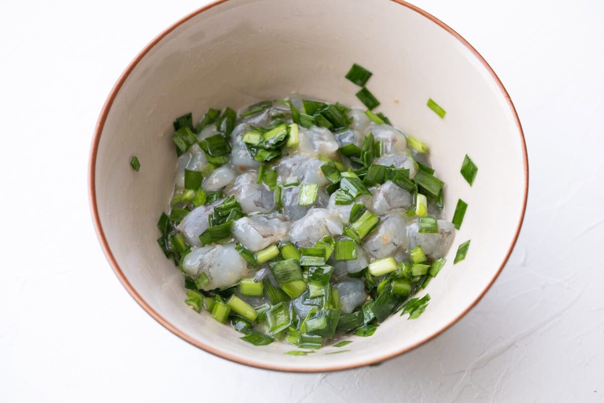 Shrimp and chives in a bowl. 