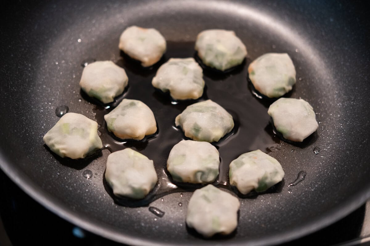 Dumplings are being pan fried. 