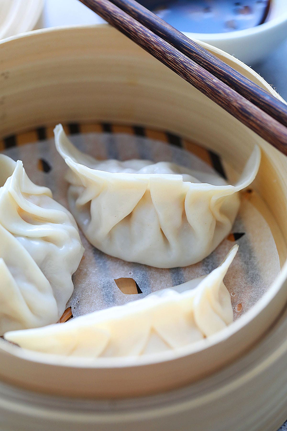 Steamed dumplings in a bamboo steamer. 