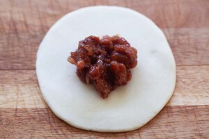 Char siu bao dough with char siu filling in the middle of the dough.