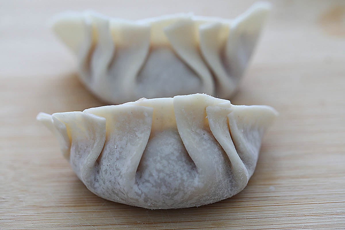 Perfect dumplings wrapped in a crescent shape with pleats. 