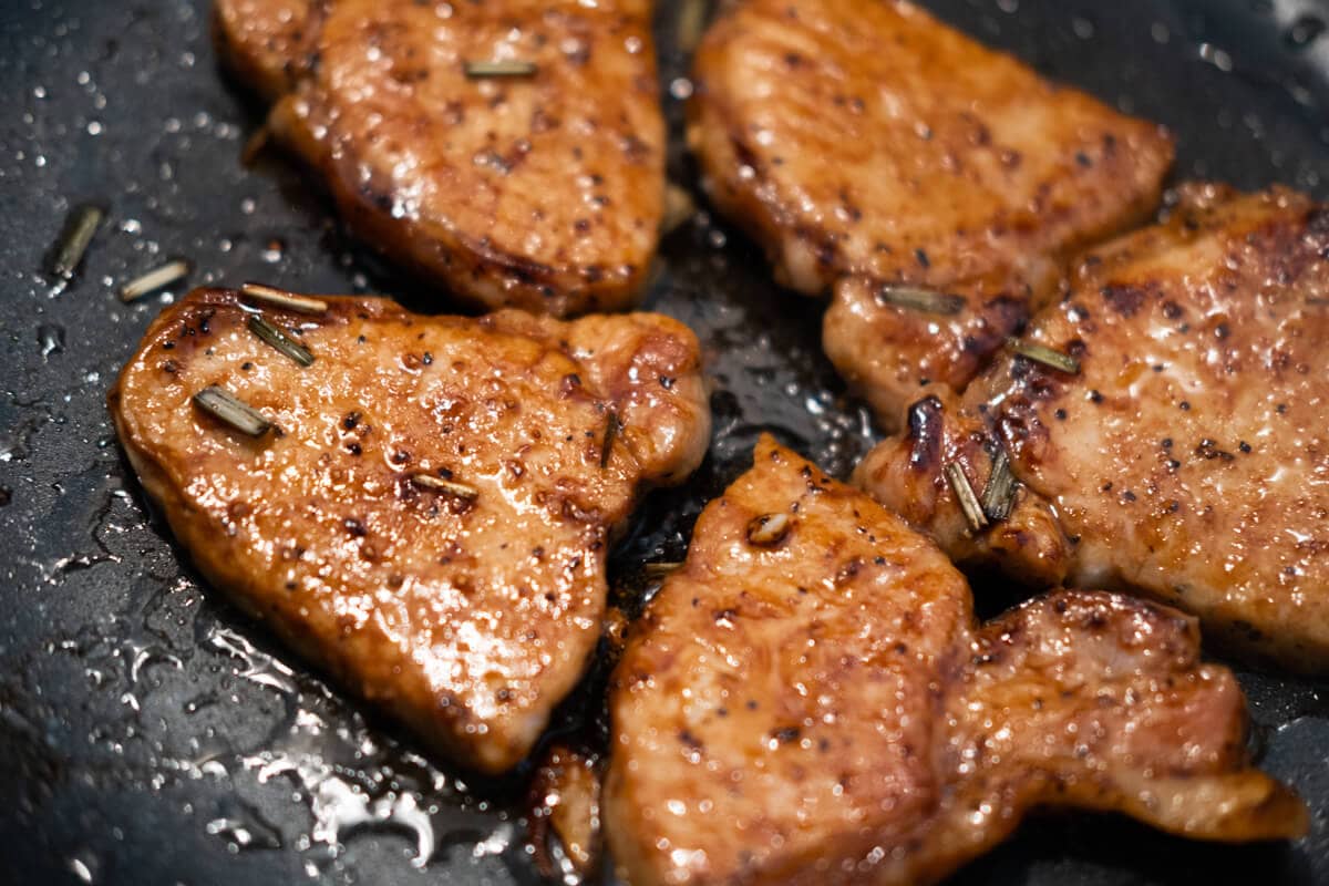 Marinated pork being cooked on a grill. 