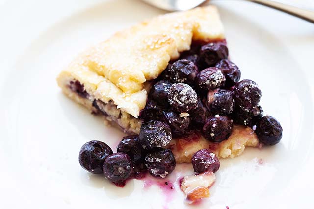 Blueberry lemon galette on a white plate.