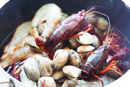 Boiling seafood in a large pot.