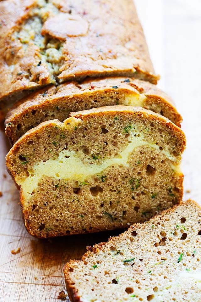 Loaf of quick bread with zucchini and a ribbon of cheesecake.