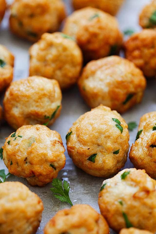 Golden brown ground chicken meatballs with cilantro leaves. 