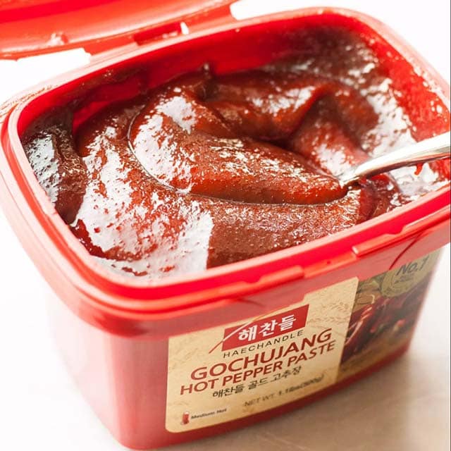 Gochujang in a plastic tub, used as a sauce for Korean fried chicken. 