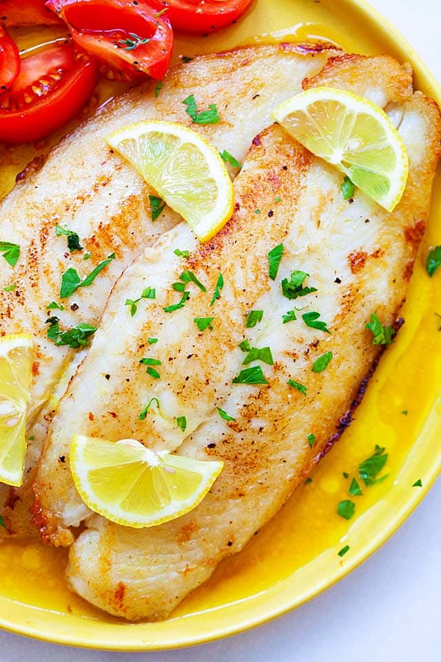 Close up of crispy pan fried swai fish in a lemon butter sauce.