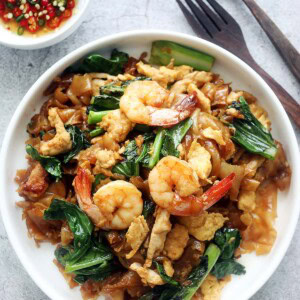 Pad See Ew (pad see yew or phat si-io) with shrimp, chicken and vegetables on a plate.