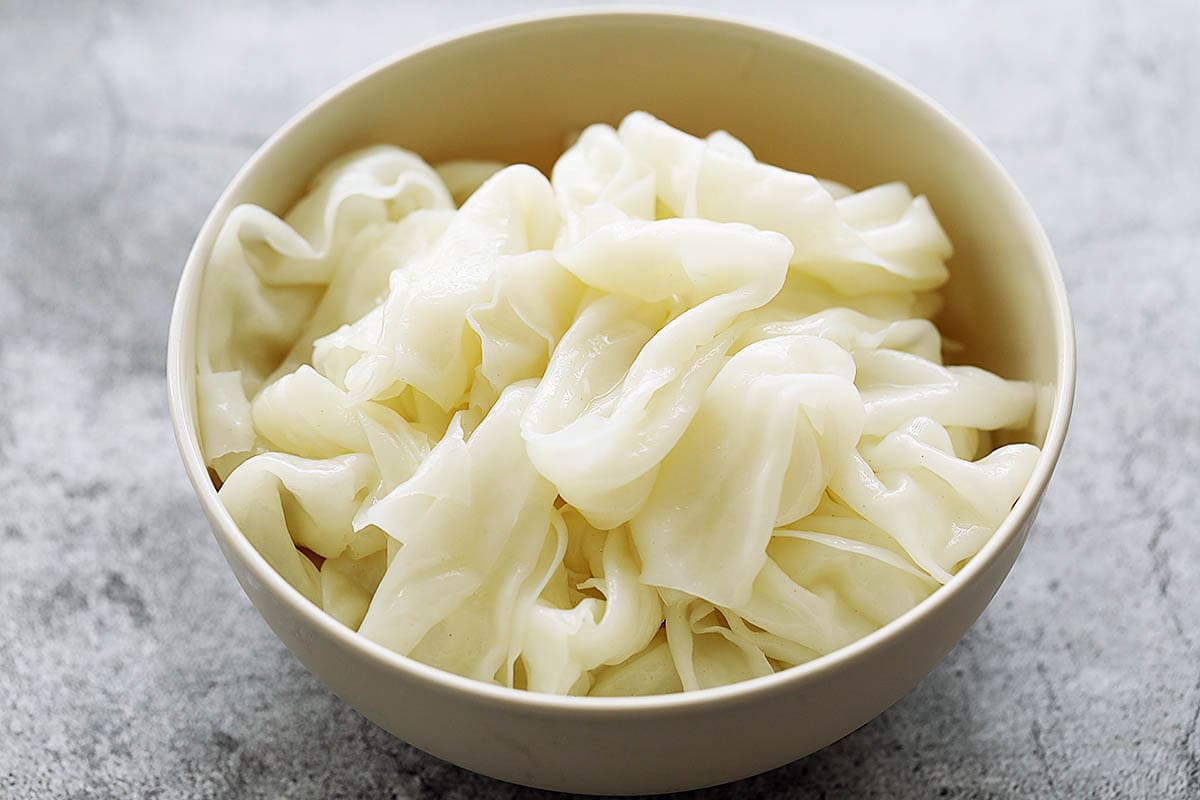 Fresh pad see ew noodles (flat rice noodles) in a bowl. 