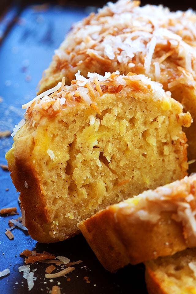 slice of Pina Colada bread topped with coconut leaning against remaining quick bread