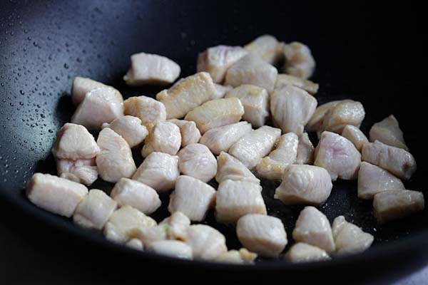 Tender chicken meat in a wok.