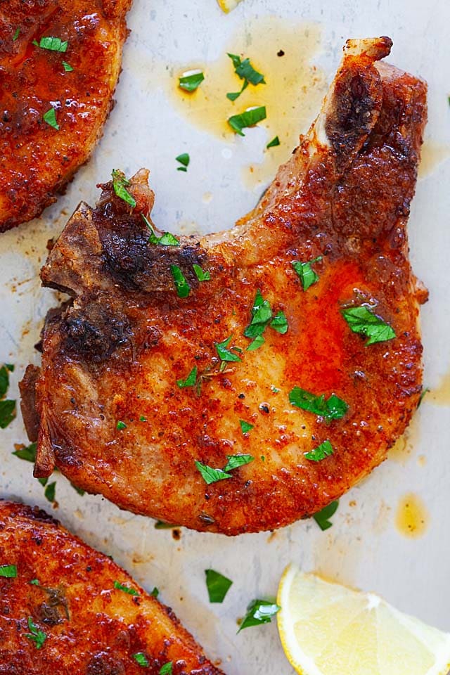 Tender and marinated baked pork chops bone in.