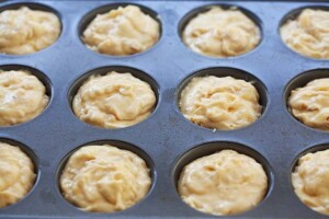 Banana nut muffins in a muffin pan.