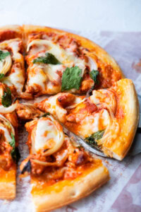 Easy and delicious homemade Indian pizza with chicken tikka masala as pizza topping.