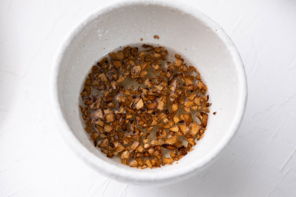 Cooked garlic oil in a small bowl. 