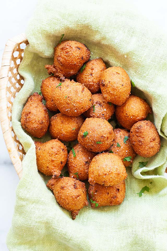 Hush puppies in a serving tray with spicy mayonnaise dipping sauce.