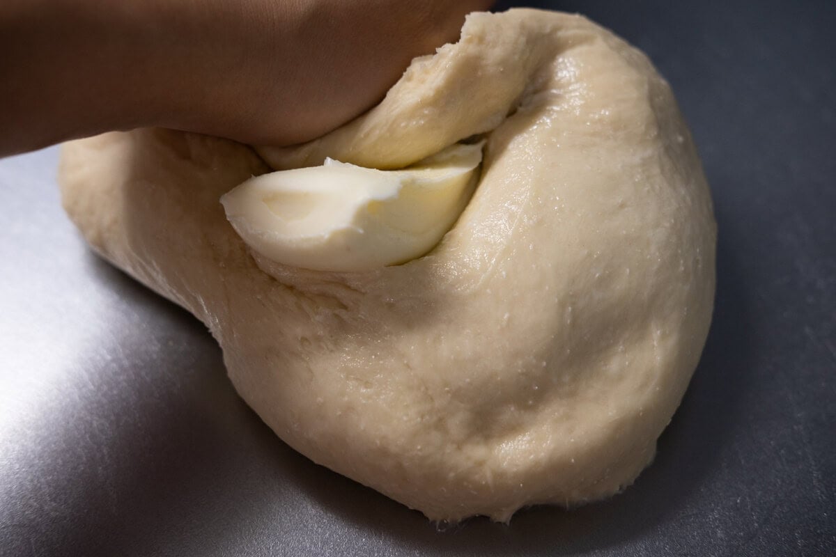 Knead the unsalted butter into the dough. 