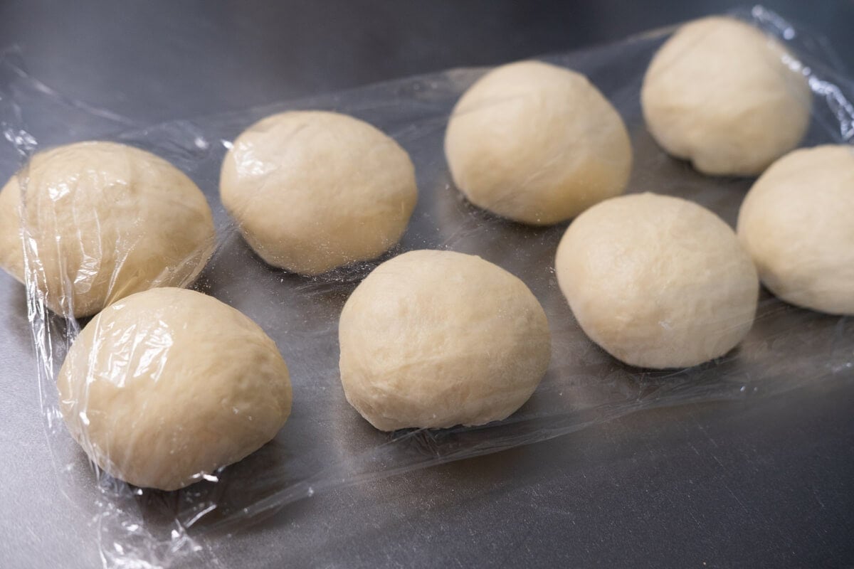 Divide the dough into 8 pieces and cover with the plastic wrap. 