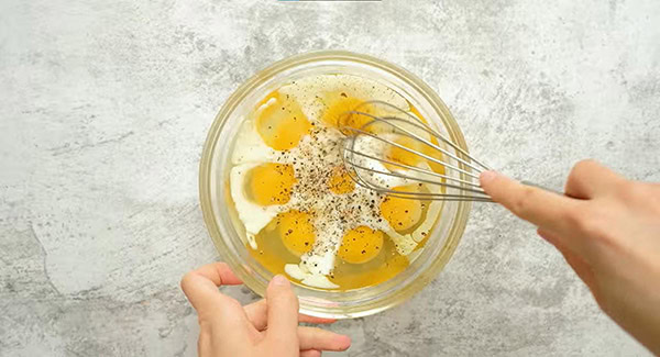 Whisk together eggs, milk, salt, and pepper.