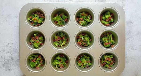 Divide the broccoli and bacon evenly among the muffin cups.