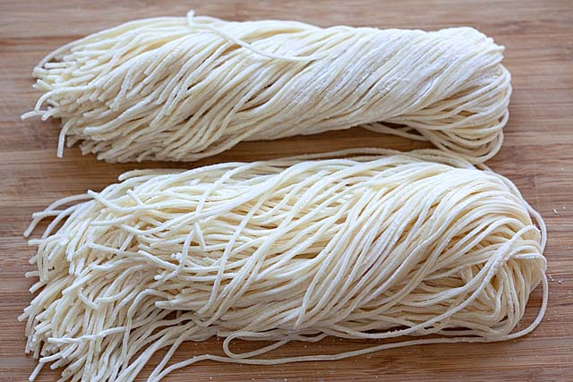 Fresh noodles on a chopping board. 