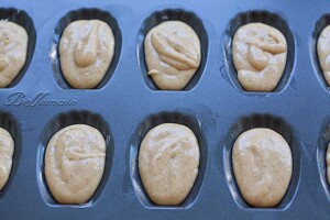 Madeleine batter in a madeleine mold pan.