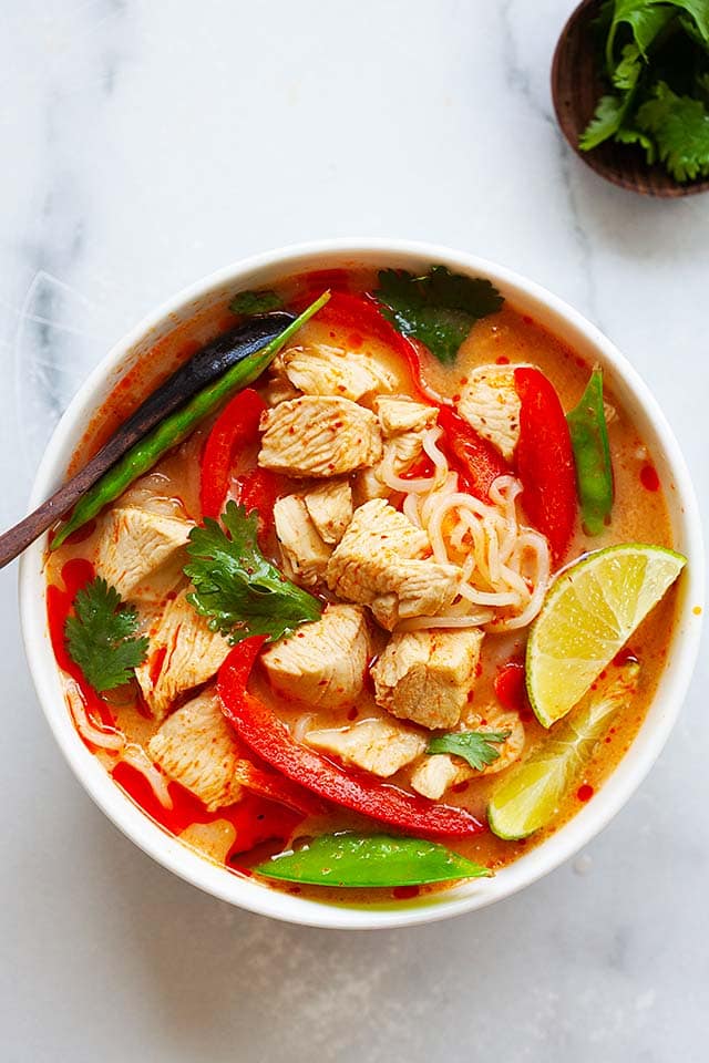 Thai chicken noodles soup in a serving bowl.