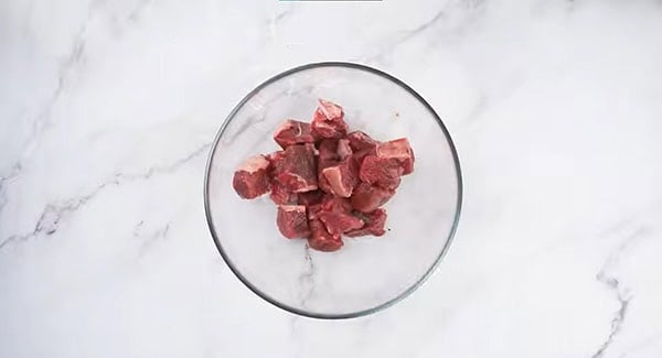 Bite sized pieces of sirloin steak in a bowl.