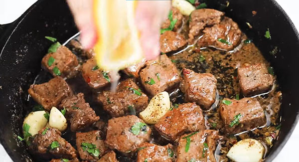 Drizzle lemon juice over the garlic butter steak bites. 