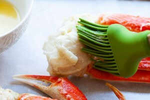 Brushing butter on snow crab.