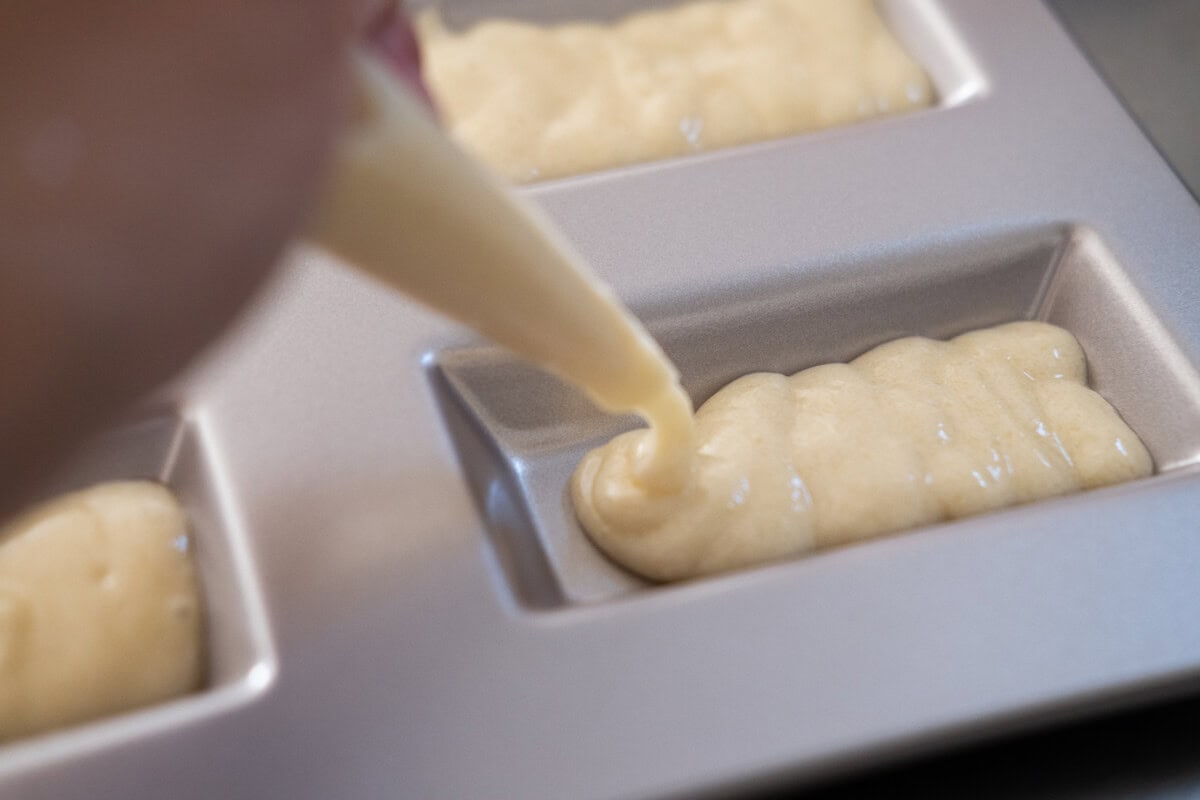 Pipe the batter into a financier mold. 