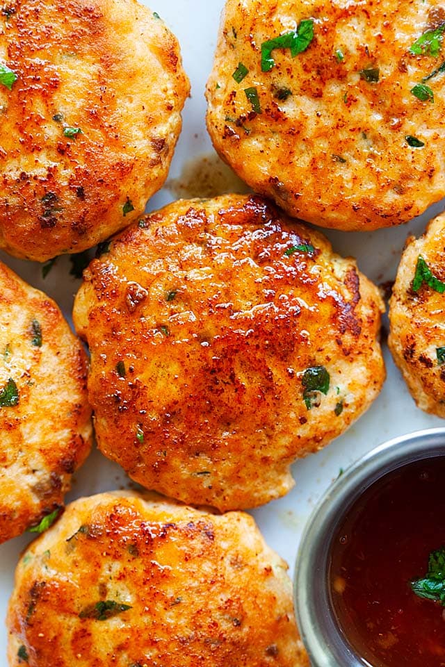 Salmon cakes made of fresh salmon with salmon cake sauce on a plate.