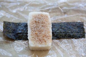 Wrapping musubi with nori seaweed.