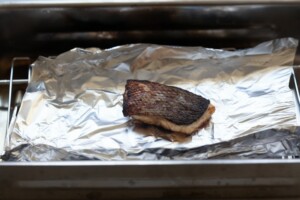 Branzino in a smoker grill.