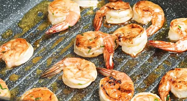 Marinated shrimp on a grill.