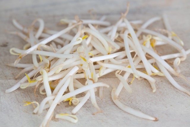 Bean sprouts on a chopping board. 