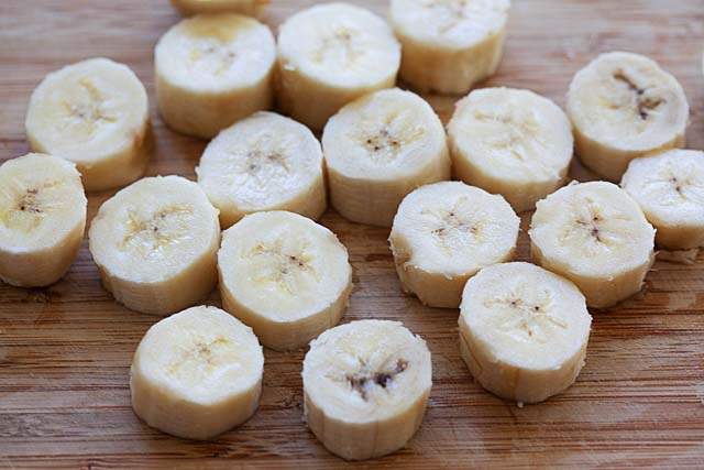 Sliced banana pieces on a chopping board.